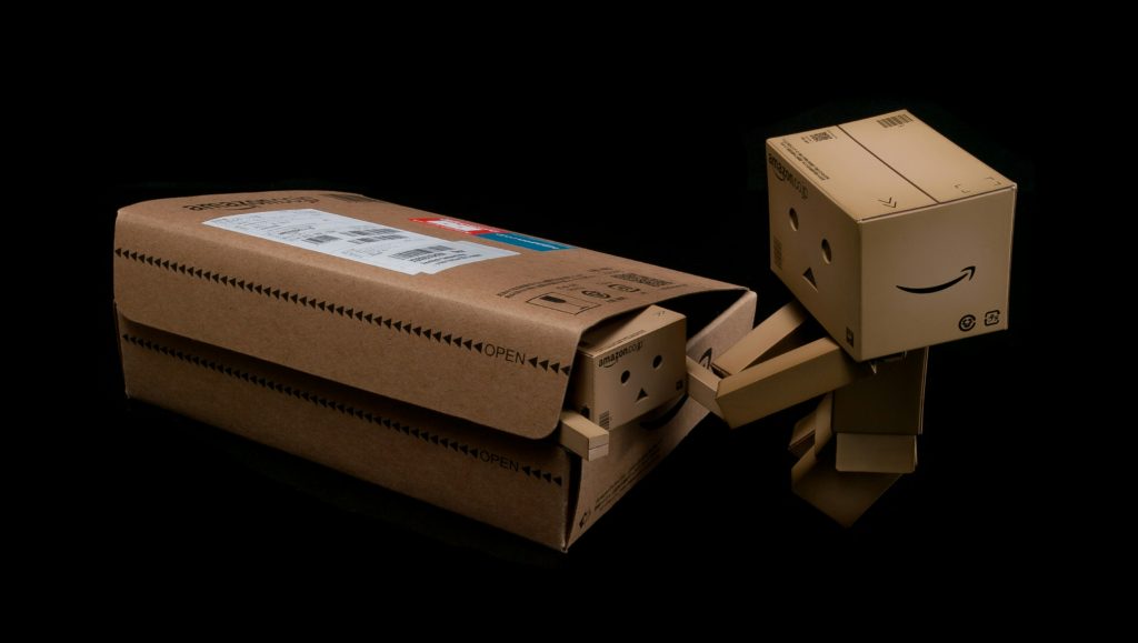 a-large-cartoon-character-made-out-of-boxes-pulling-a-small-stuck-cartoon-character-out-of-a-large-box